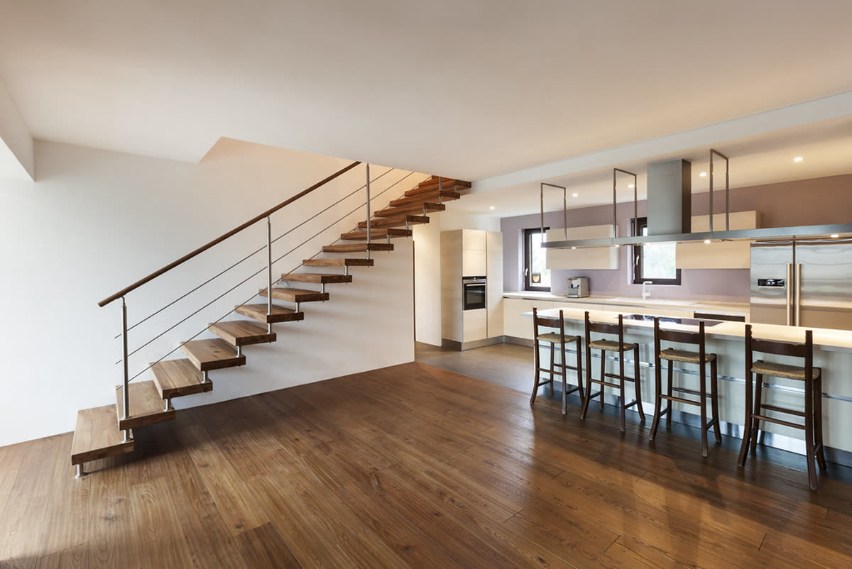 Kitchen with floating wooden staircase, original listing photo